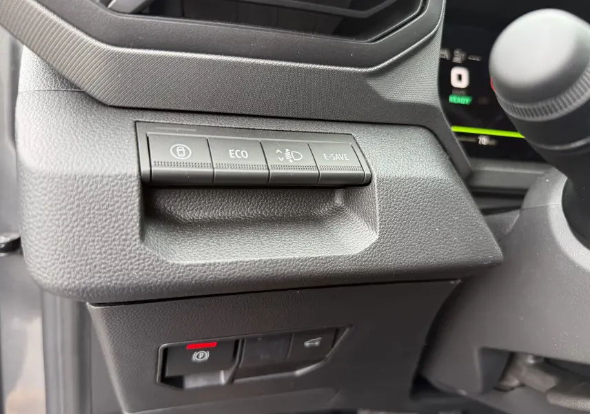 Gros plan sur les boutons de commande à gauche du volant du Dacia Bigster 2026, intérieur noir texturé.