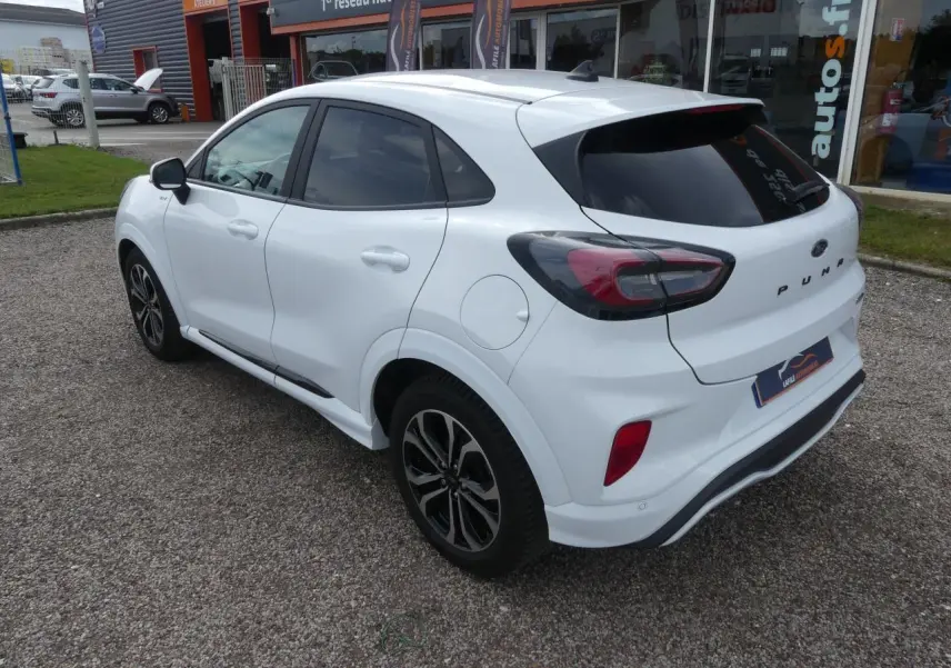 Vue 3/4 arrière droite d'un Ford Puma blanc avec vitres arrière surteintées et jantes alliage noires.