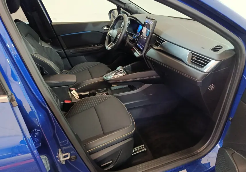 Vue intérieure côté conducteur de la Renault SYMBIOZ bleu 2025, avec tableau de bord moderne et écran tactile vertical.