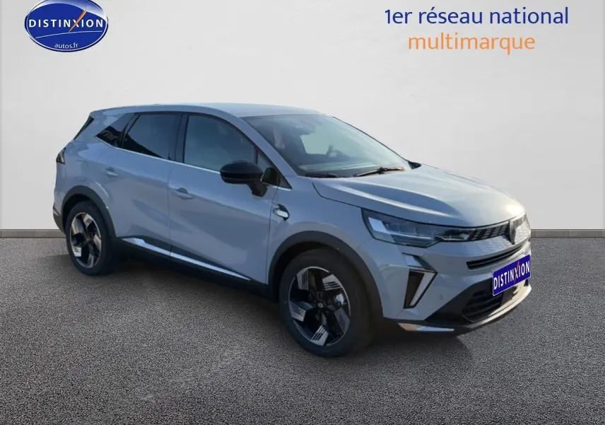 Renault Symbioz gris rafale en 3/4 avant droit, avec jantes alliage et vitres arrière surteintées.