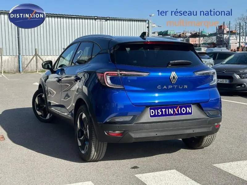 Vue 3/4 arrière droite du Renault Captur 2025 en Bleu Iron/Noir Etoilé, avec feux arrière LED et logo distinctif Renault.