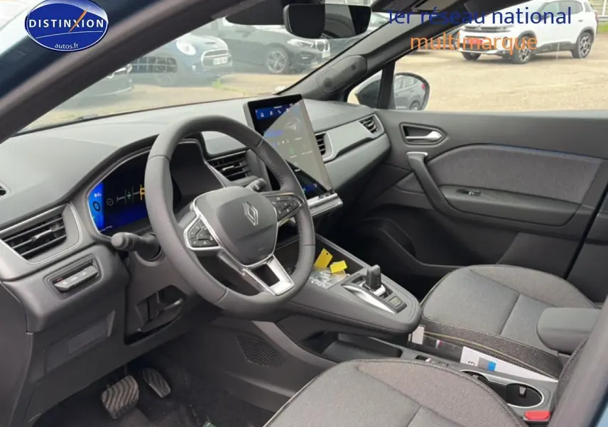 Vue intérieure côté conducteur de la Renault Symbioz 2026, tableau de bord moderne avec écran tactile vertical et sellerie textile grise.