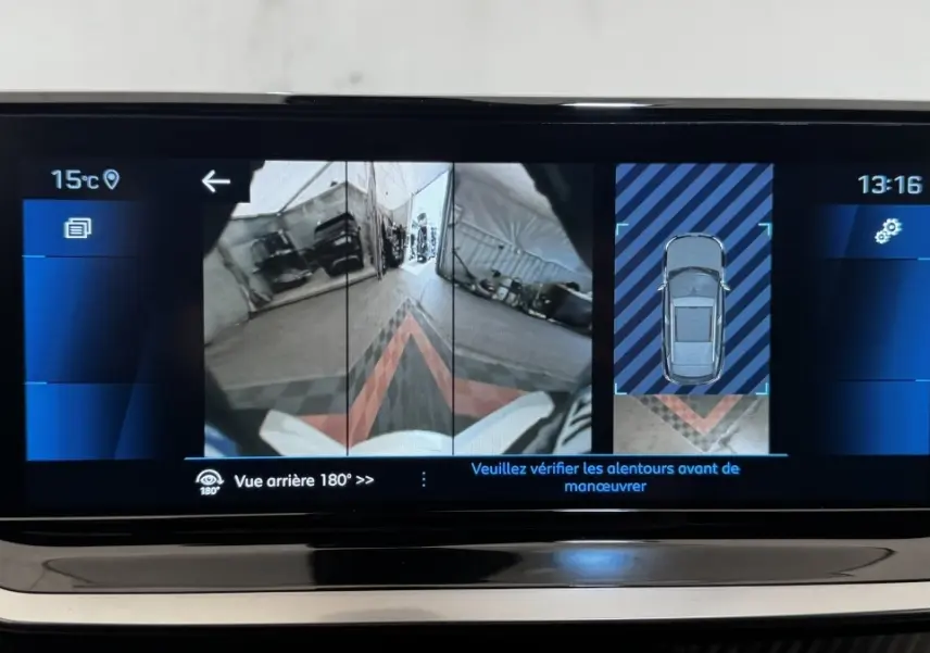 Écran tactile intérieur du Peugeot 2008 gris foncé montrant la caméra de recul et l'affichage 360° du stationnement.