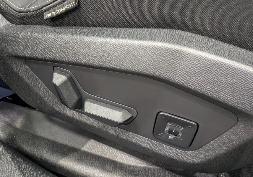 Gros plan sur les commandes électriques de réglage du siège conducteur noir du Peugeot 5008 Hybrid 145 GT 2025.