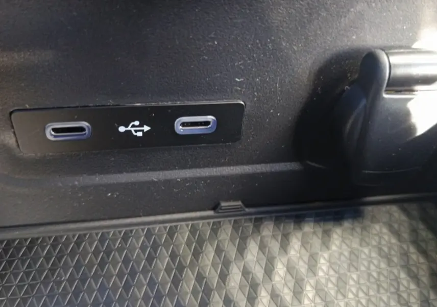 Gros plan sur deux ports USB-C et une prise 12V dans l'habitacle du Renault Austral blanc esprit Alpine.