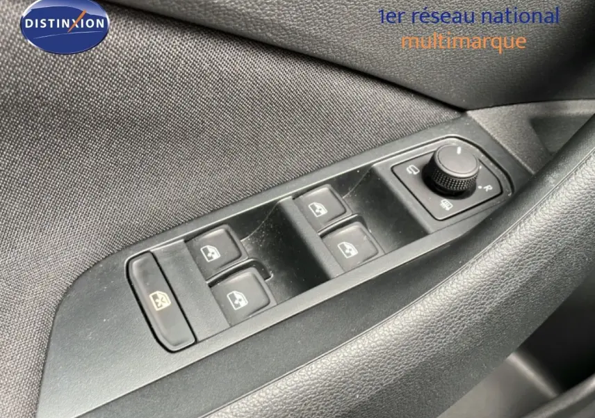 Gros plan sur les commandes des vitres et rétroviseurs côté conducteur d’une Skoda Scala noire, finition 2025.