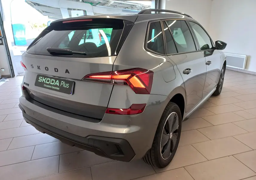 Vue 3/4 arrière droite du Skoda Kamiq Monte Carlo gris graphite 2024, avec feux arrière allumés et jantes spécifiques.