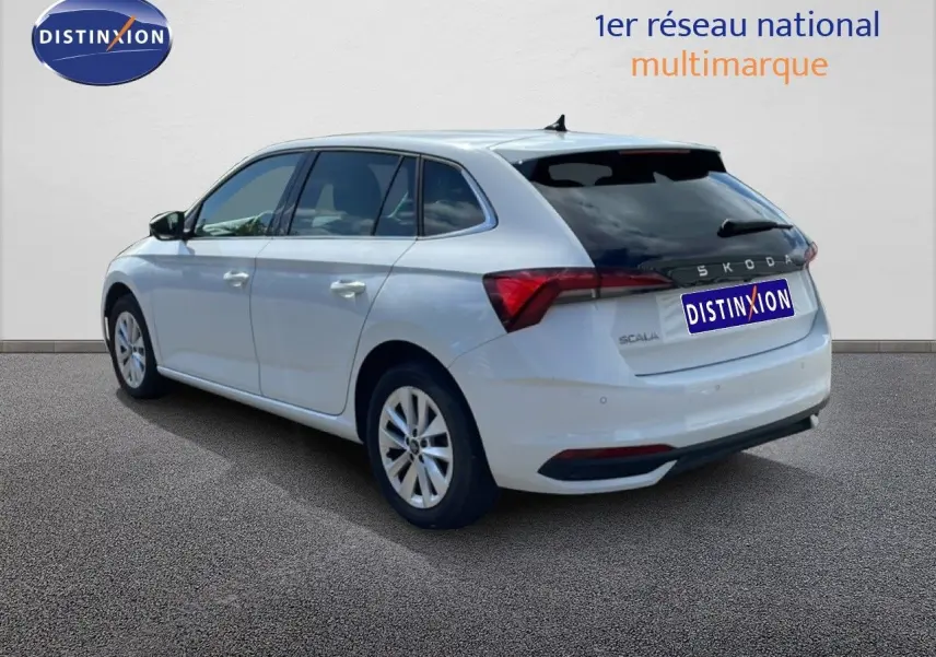 Vue 3/4 arrière droite d'une Skoda Scala blanche glacier avec vitres teintées et jantes alliage 16 pouces.