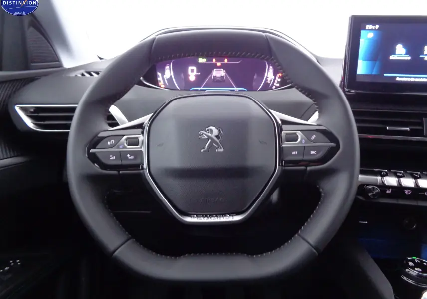 Vue centrée sur le volant cuir noir du Peugeot 3008 2023 avec tableau de bord numérique et écran tactile visible.