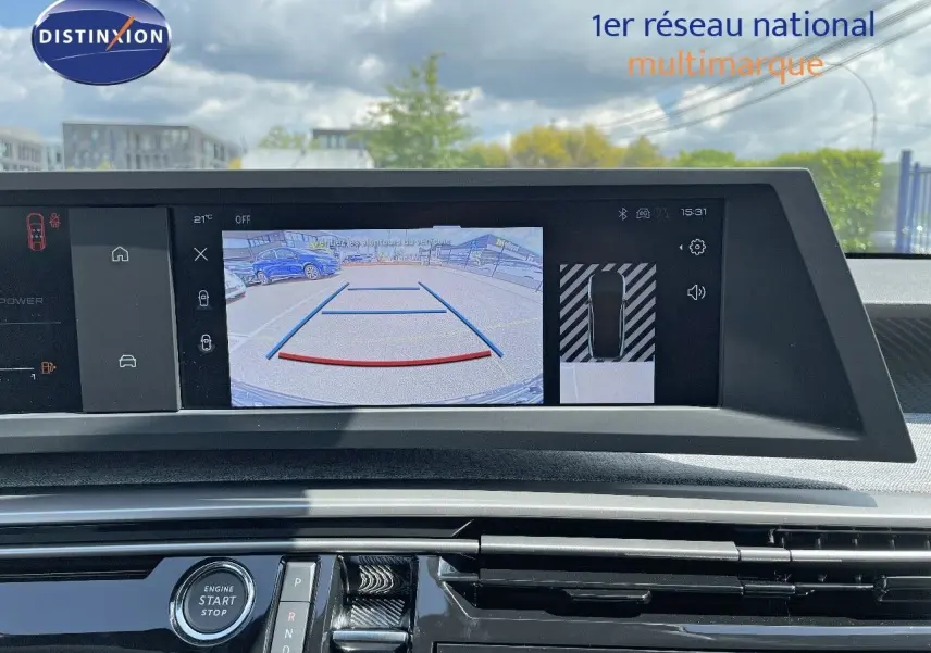 Vue intérieure du tableau de bord du Peugeot 3008 Hybrid 2025, écran affichant la caméra de recul avec guidage.