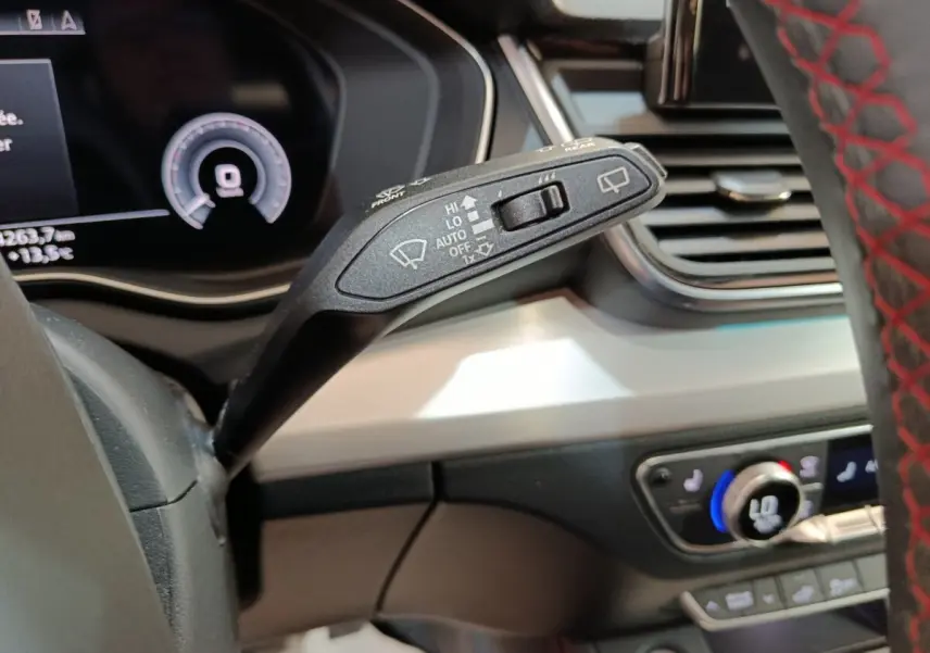 Gros plan sur la commande d’essuie-glace à gauche du volant dans l’Audi Q5 gris clair hybride rechargeable 2023.