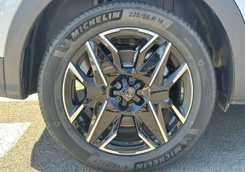 Gros plan sur la jante alu noire et argentée du PEUGEOT 5008 blanc Okénite, pneu Michelin 225/55 R19.
