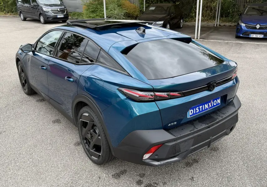 Vue 3/4 arrière droite d'une Peugeot 408 PHEV 225 GT bleu avec toit panoramique et feux arrière LED distinctifs.