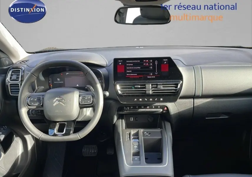 Vue intérieure avant du Citroën C5 Aircross 2025, tableau de bord moderne avec écran tactile et volant multifonction noir.
