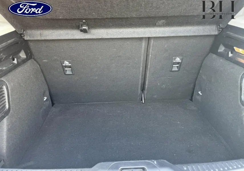 Coffre vide vu de face d’une Ford Focus 2023 gris lunaire, intérieur tissu noir avec fixations ISOFIX.