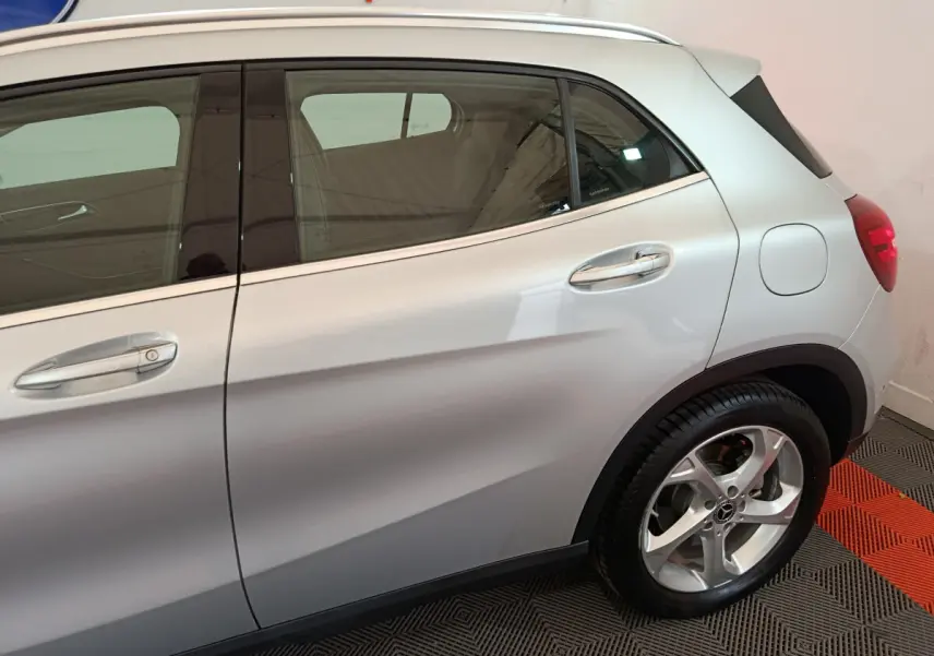Vue latérale droite d’un Mercedes GLA 200 d Business Executive gris clair, mettant en valeur les jantes alliage et les poignées chromées.