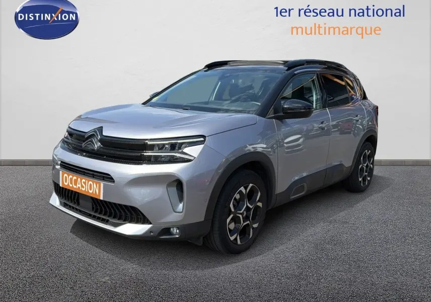 Citroën C5 Aircross gris acier en 3/4 avant droit, avec jantes bi-ton et toit noir contrasté.