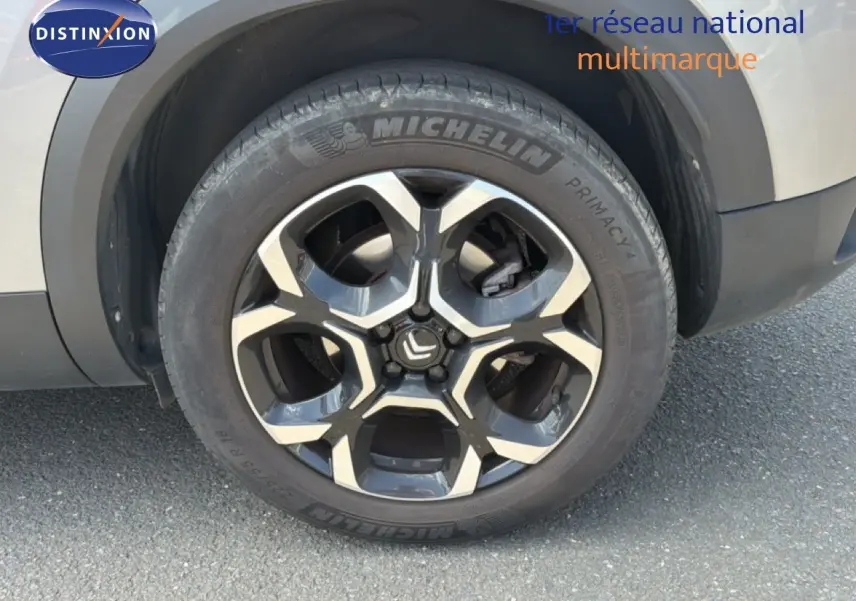 Gros plan sur la roue avant droite du Citroën C5 Aircross gris acier, avec jante alliage bicolore et pneu Michelin.