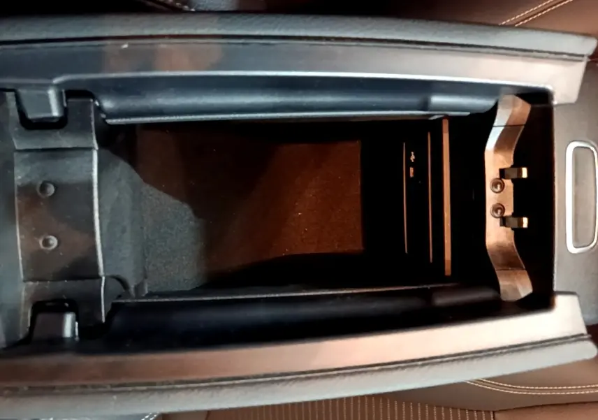 Vue plongeante sur l'accoudoir central ouvert de la Mercedes CLA 200 d Business Line 2021, intérieur cuir brun.