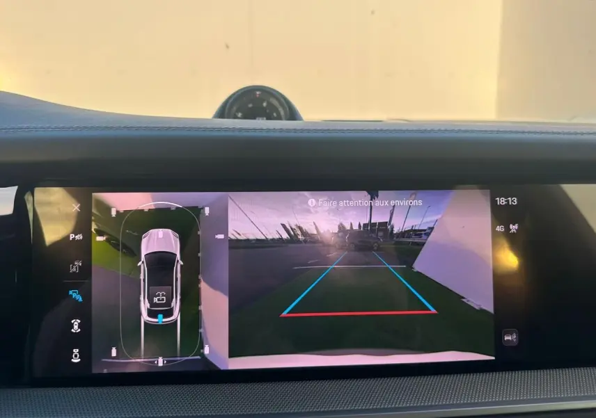Écran intérieur du Porsche Cayenne 2024 montrant la caméra de recul et la vue 360° du véhicule en gris arctique.