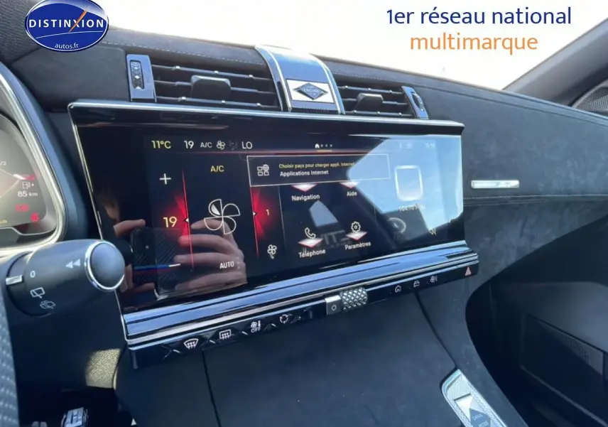 Vue intérieure côté passager du tableau de bord du DS7 bleu, mettant en valeur l'écran tactile et les commandes modernes.