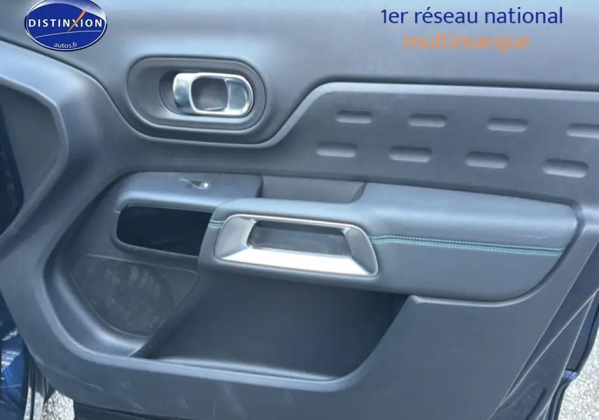 Gros plan sur la porte côté gauche du Citroën C5 Aircross bleu eclipse avec poignée argent et surpiqûres bleues.