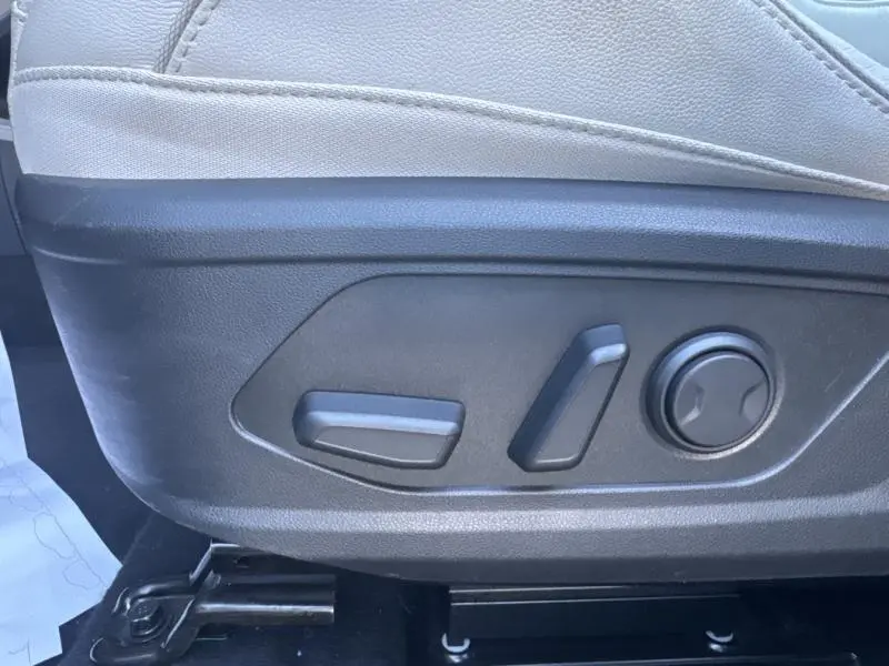 Gros plan sur les commandes électriques de réglage du siège avant du Hyundai Tucson 2021 en cuir clair.