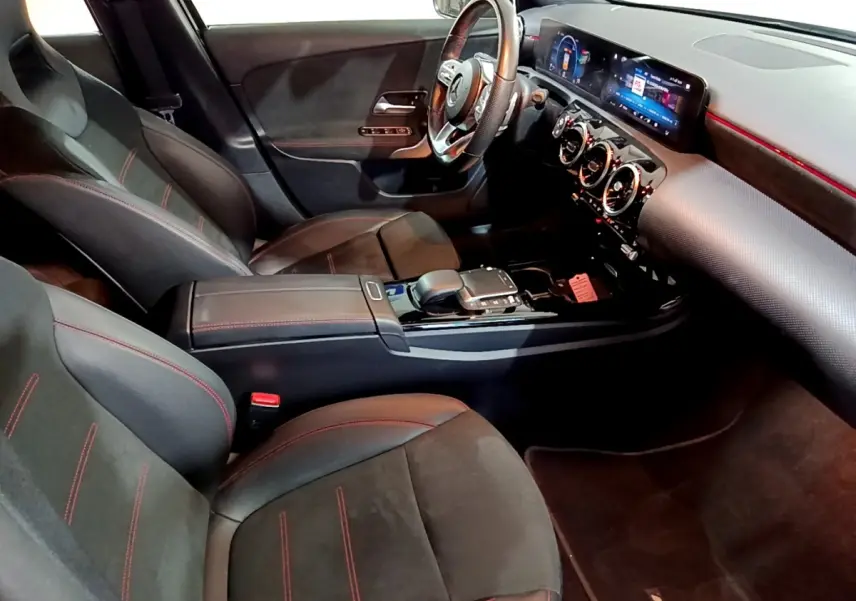 Intérieur noir de la Mercedes Classe A 200 AMG Line, vue côté conducteur, avec sièges sport et tableau de bord numérique.