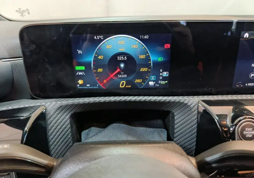 Vue rapprochée du tableau de bord numérique de la Mercedes Classe A bleu, affichant la vitesse et les indicateurs.