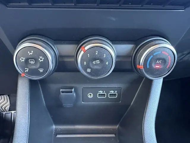 Détail des commandes de climatisation manuelle et des ports USB dans l’habitacle gris de la Renault Clio V Blue dCi 2025.