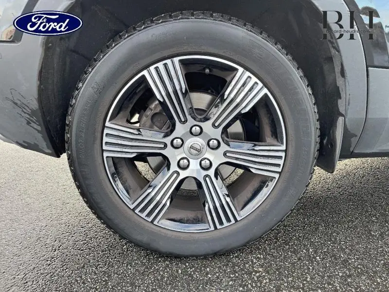 Gros plan sur la roue avant gauche noire du Volvo XC40 D3 Inscription Luxe avec jante alu distinctive.