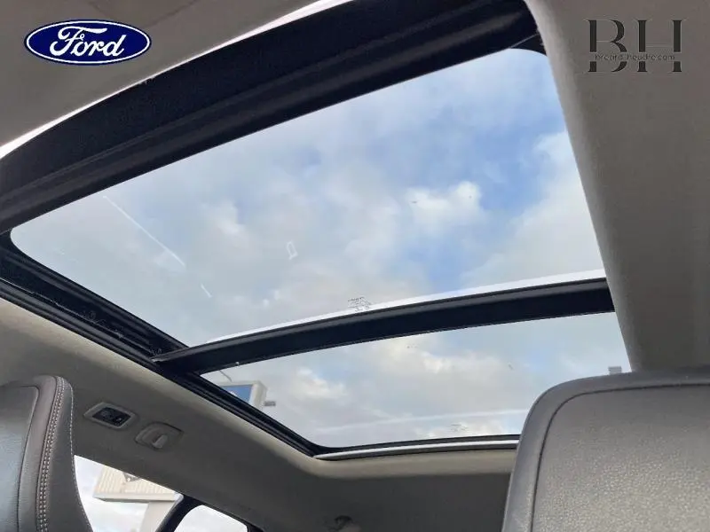 Toit ouvrant panoramique vu de l'intérieur d'un Volvo XC40 noir, soulignant la luminosité naturelle.