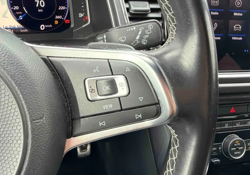 Vue rapprochée du volant cuir multifonctions et du tableau de bord digital du Volkswagen T-Roc gris Indium 2020.