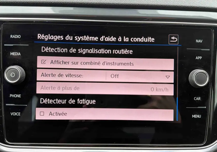 Écran tactile intérieur du Volkswagen T-Roc affichant les réglages d'aide à la conduite, vue de face.
