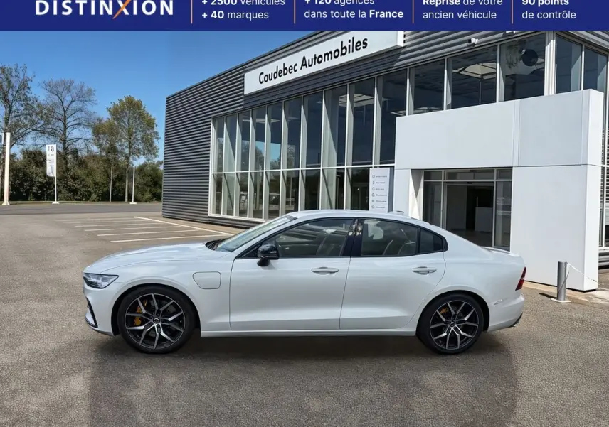 Profil droit d'une Volvo S60 T8 Twin Engine blanche, avec jantes noires à cinq branches et étriers de frein jaunes.