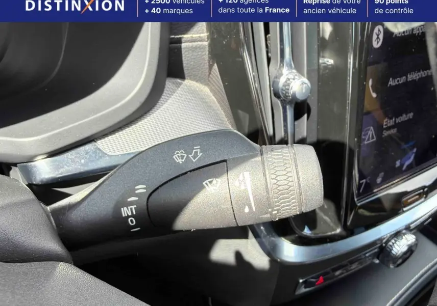 Gros plan sur la commande d’essuie-glace du Volvo S60 T8, avec tableau de bord et écran tactile en arrière-plan.