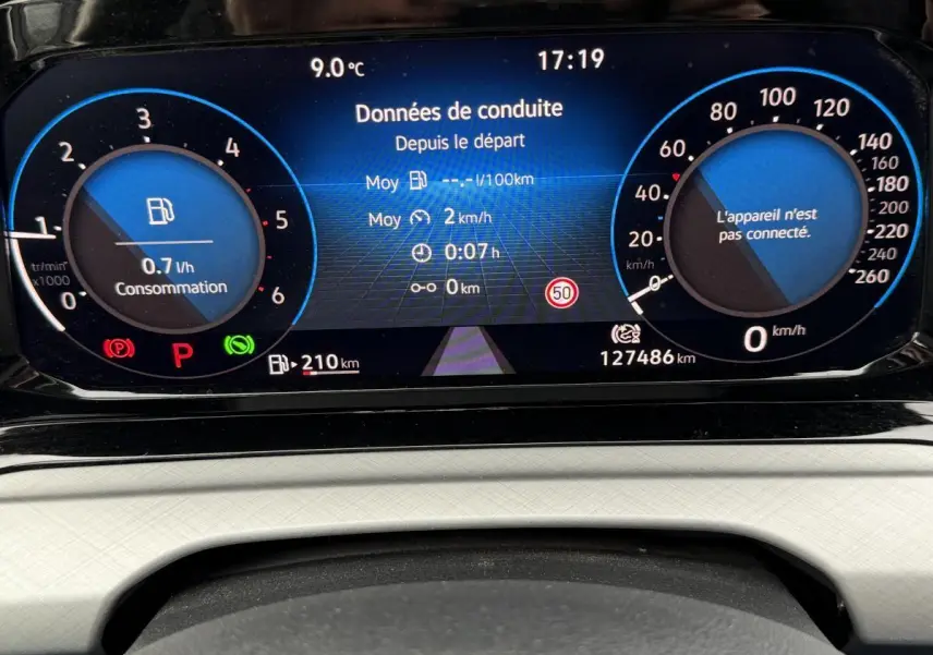 Vue rapprochée du tableau de bord digital bleu et noir de la Volkswagen Golf SW 2.0 TDI 2022 affichant données de conduite.