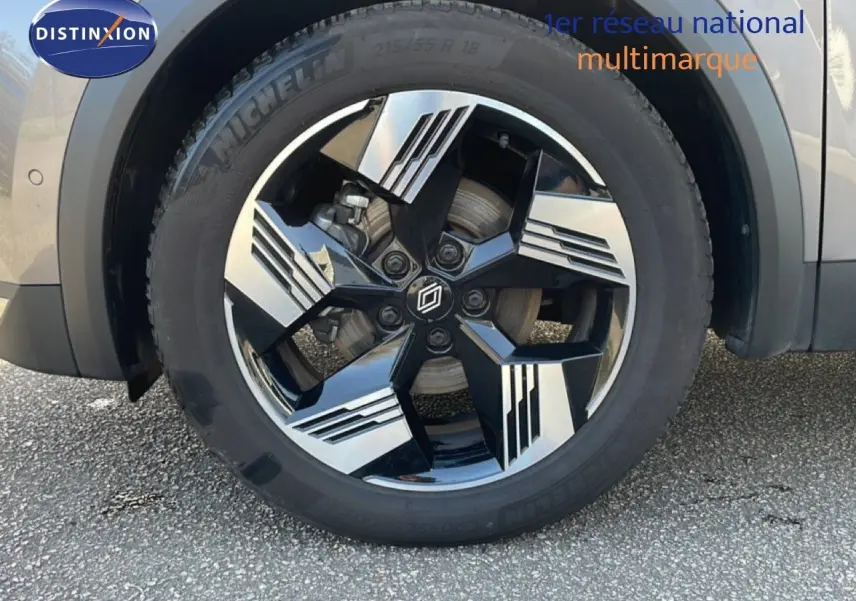 Gros plan sur la roue avant droite du Renault Symbioz gris cassiopée métal avec jante alliage noire et argentée design moderne.