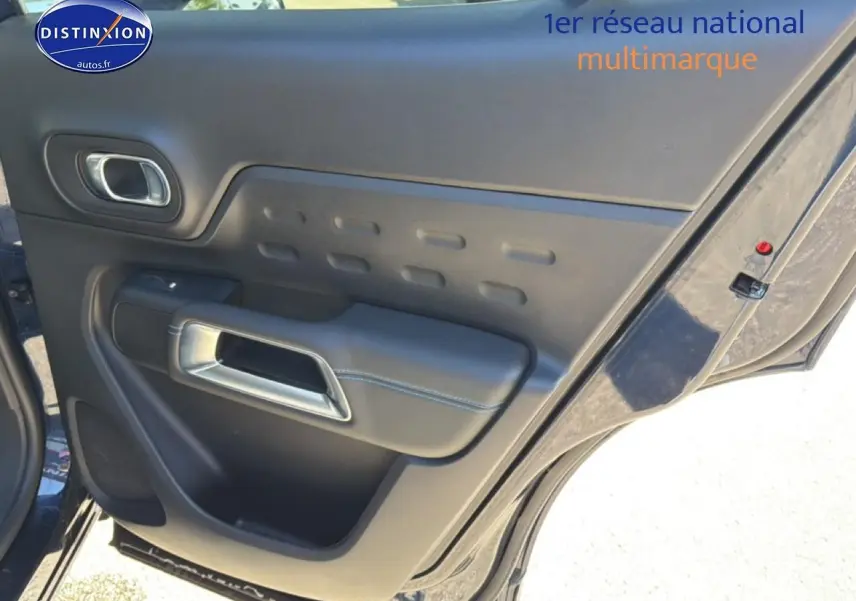 Vue rapprochée de la porte arrière gauche bleu eclipse du Citroën C5 Aircross 2025 avec poignée chromée et accoudoir noir.
