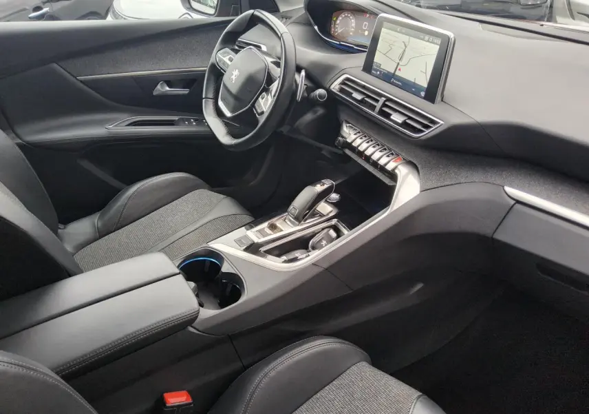Intérieur de Peugeot 3008 2019 vu côté conducteur, avec tableau de bord numérique et console centrale moderne noire.