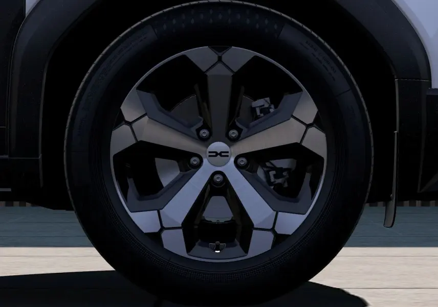 Gros plan sur la roue avant droite du Dacia Duster 2026, jante alliage bicolore noire et argent.