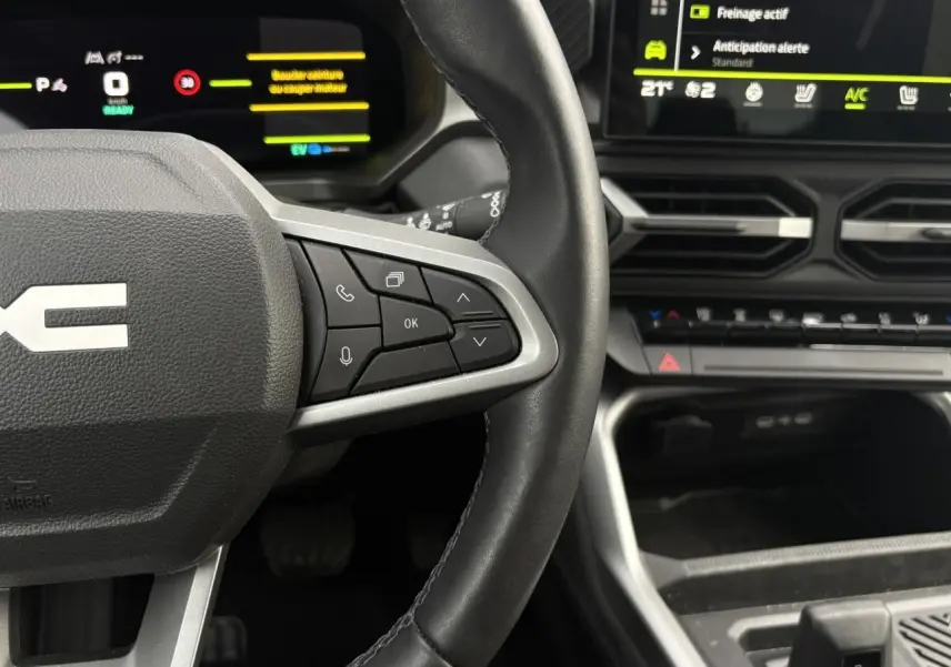 Vue rapprochée du volant noir avec commandes multifonctions et tableau de bord numérique du Dacia Bigster 2025.