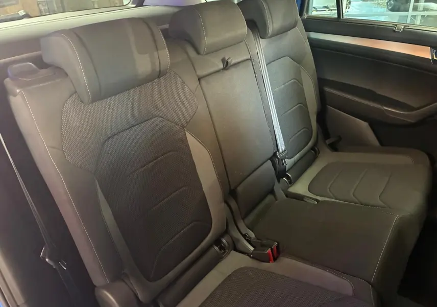 Vue intérieure des sièges arrière en tissu noir du Skoda Kodiaq 2023, version 7 places, avec ceintures visibles.