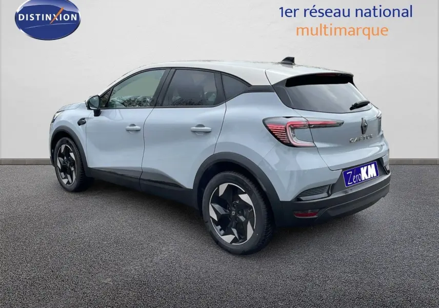 Vue 3/4 arrière gauche d'un Renault Captur gris Rafale métal avec toit beige et jantes noires stylisées.