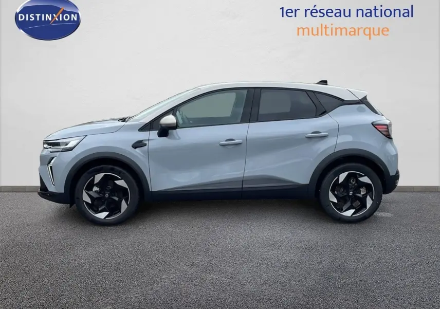 Profil latéral droit du Renault Captur E-Tech hybride gris Rafale avec toit beige et jantes noires bicolores.