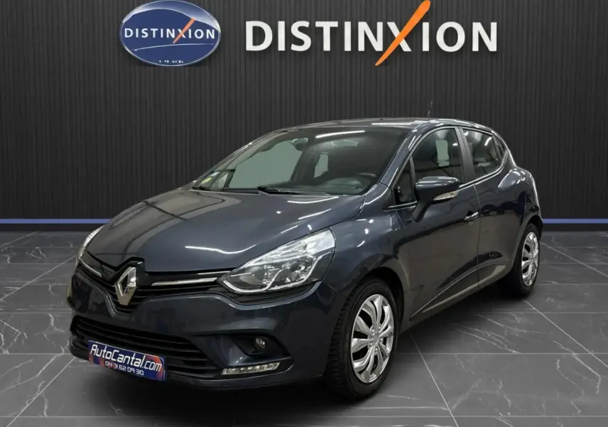 Renault Clio IV gris foncé métal vue 3/4 avant droite, avec phares LED et jantes alliage visibles en showroom.