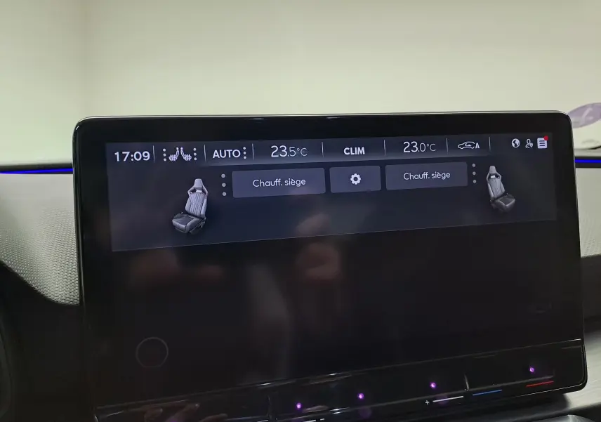 Écran tactile intérieur de la CUPRA Leon 2023 affichant les réglages de chauffage des sièges et la climatisation.