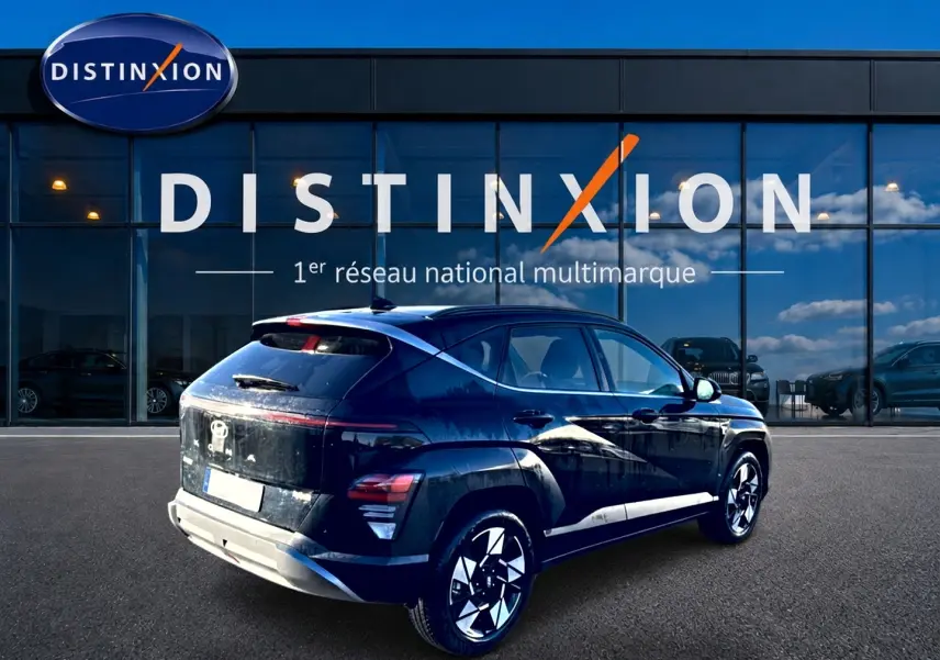 Vue 3/4 arrière droite d'un Hyundai Kona noir avec jantes alliage, devant une vitrine Distinxion.
