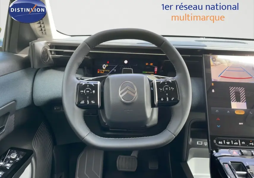 Vue intérieure centrée sur le volant du Citroën C5 Aircross Hybrid vert Astoria, avec tableau de bord numérique et écran tactile.