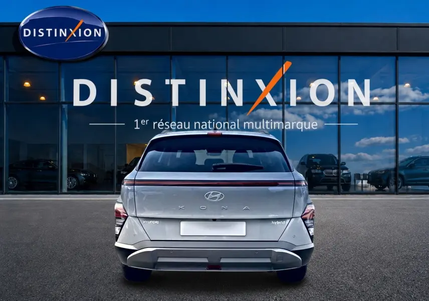 Vue arrière d'un Hyundai Kona gris hybride 2025, avec feux arrière LED et bande lumineuse distinctive.
